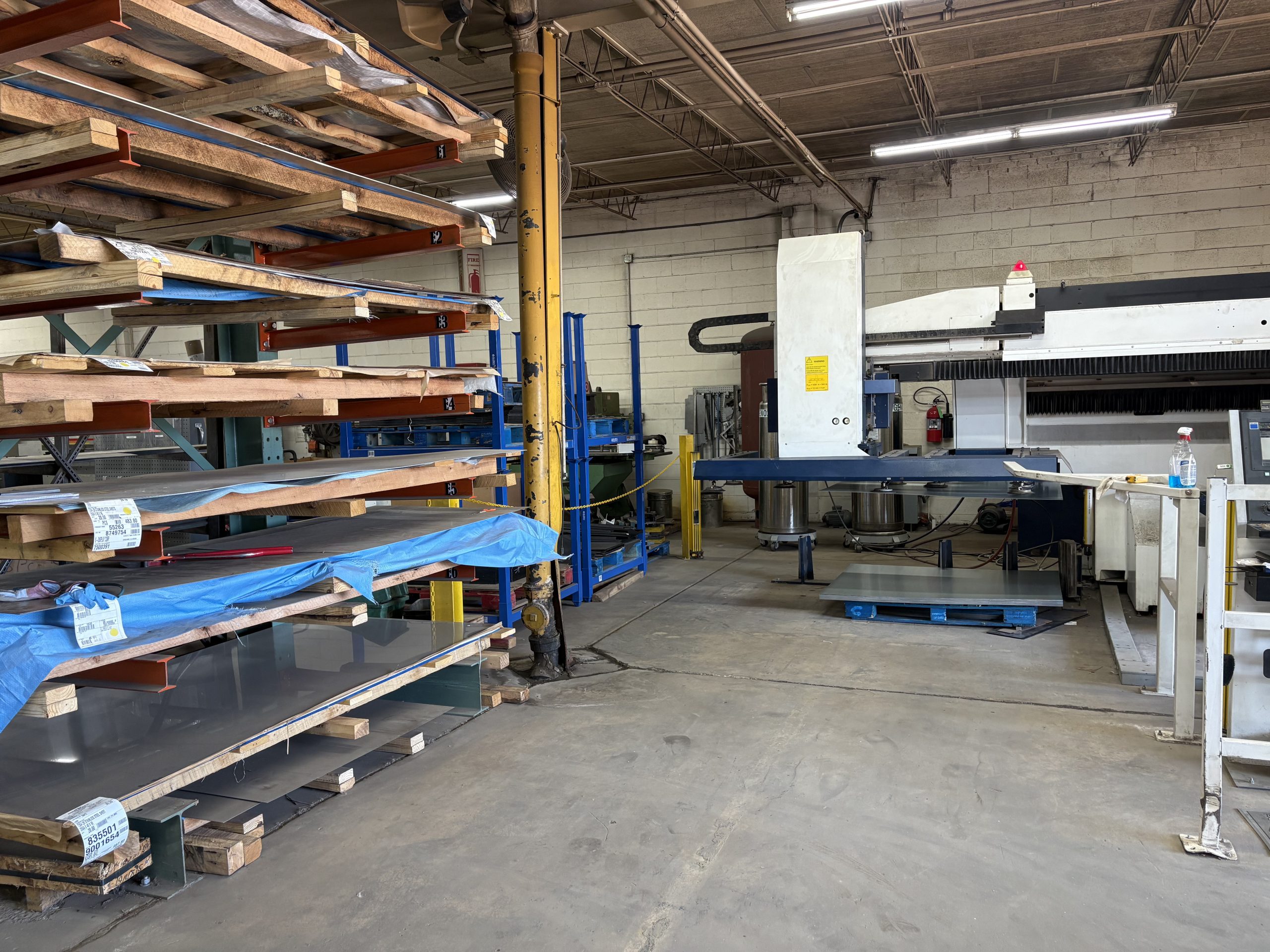 Stacked stainless steel and aluminum ready for laser cutting at K-Display’s Chicago fabrication facility